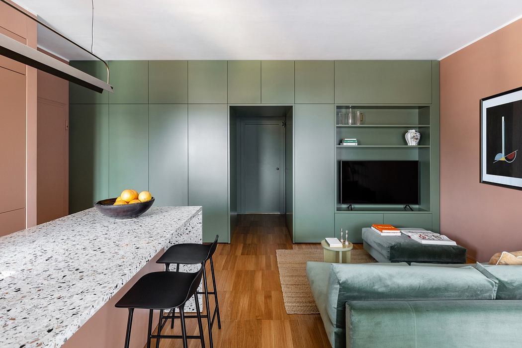 Modern kitchen with green cabinetry and a marble countertop island.