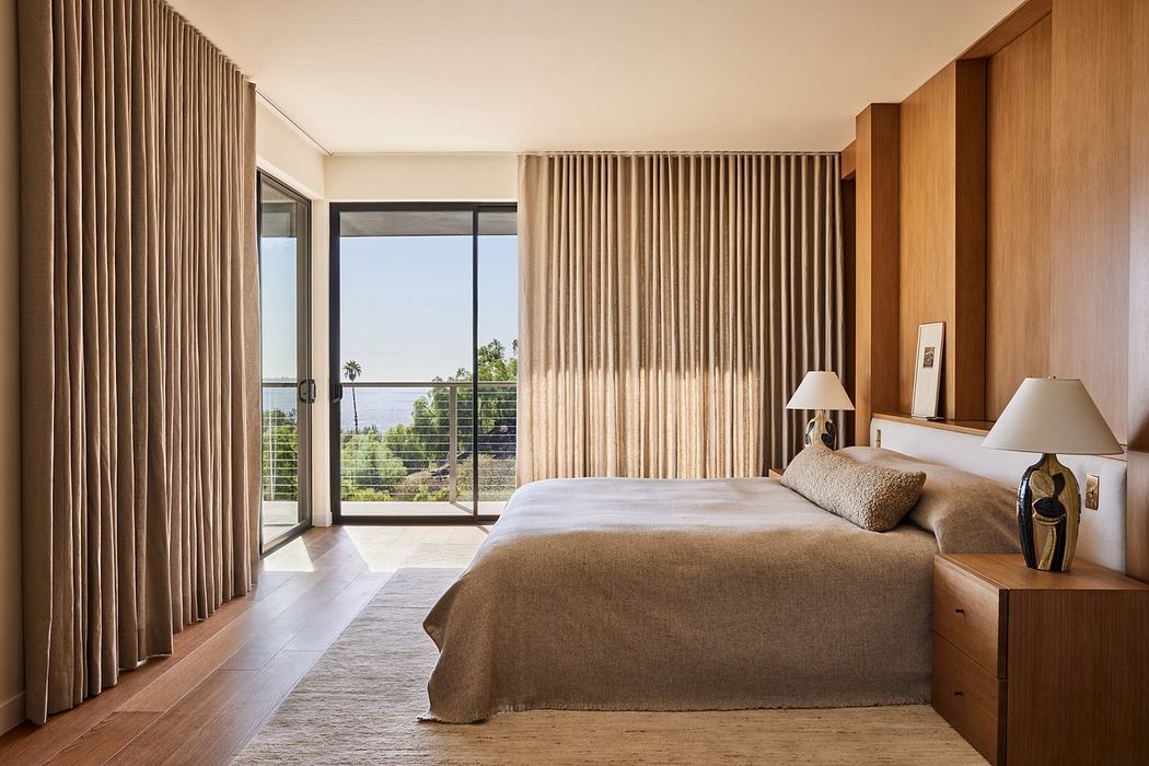 Modern bedroom with warm wood tones and large balcony doors.