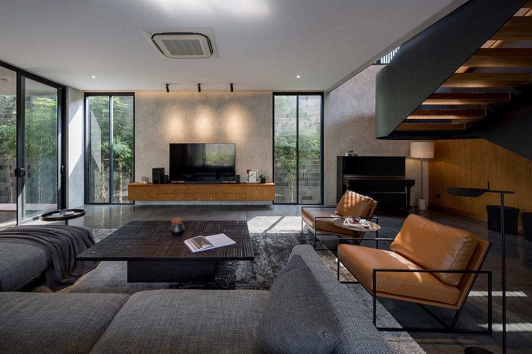 Modern living room with sleek furniture and large windows.