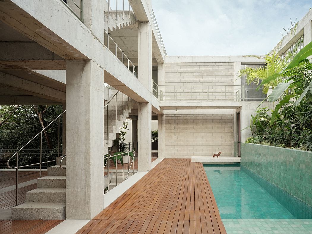 Modern courtyard with a pool, wooden deck, and concrete architecture.
