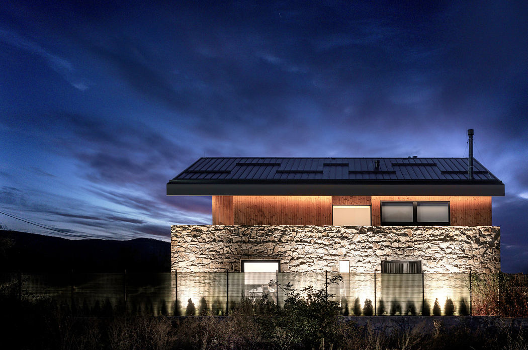 Modern house with illuminated windows at twilight.