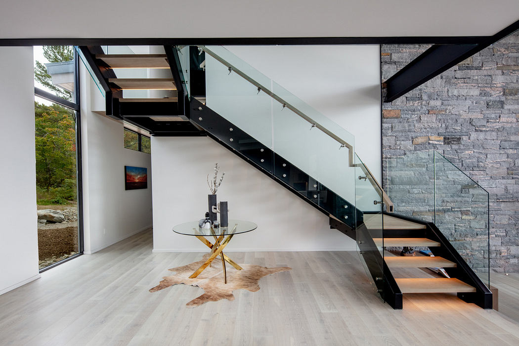 Contemporary interior with steel staircase and glass balustrade.