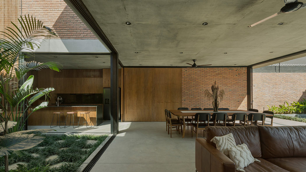 Modern open-concept living space with wooden furniture and concrete ceiling.