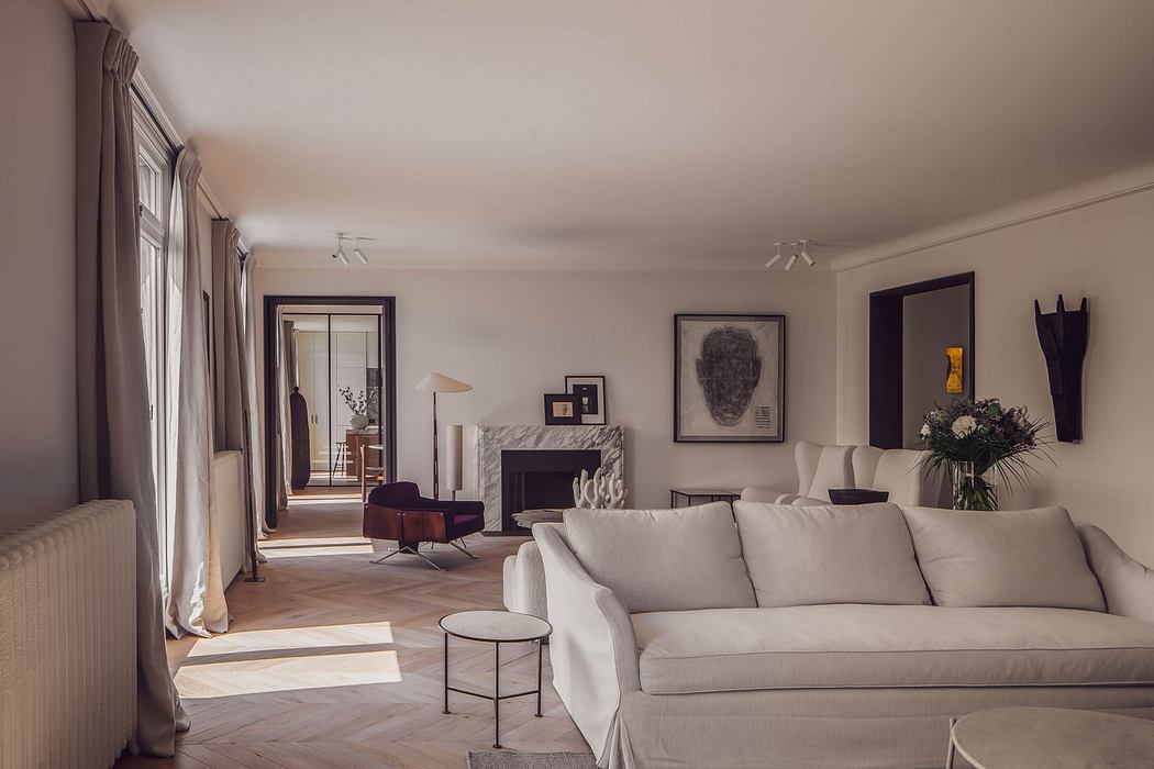Elegant living room with neutral tones, modern sofa, artwork, and natural light