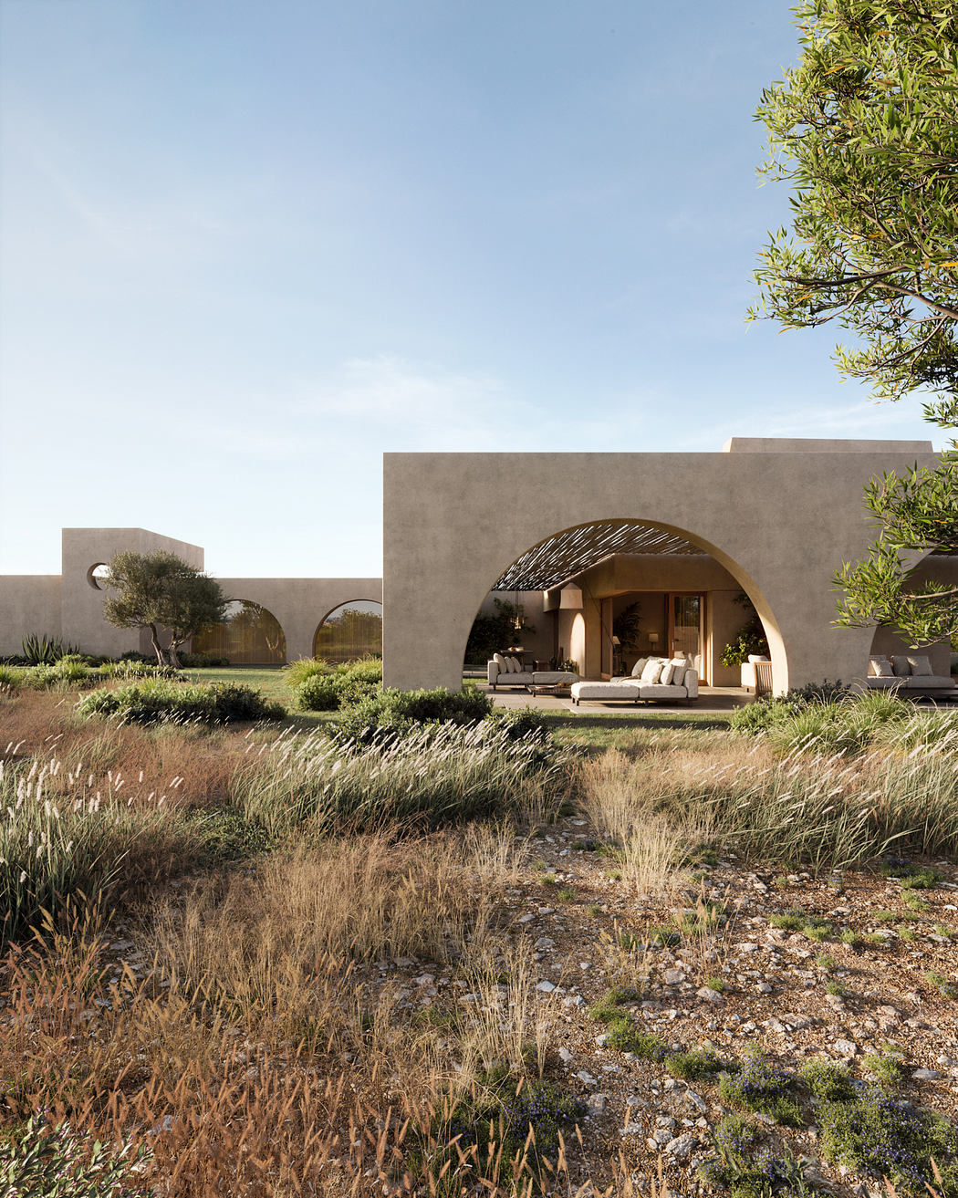 Contemporary villa with arched entrance set amidst wild grass.