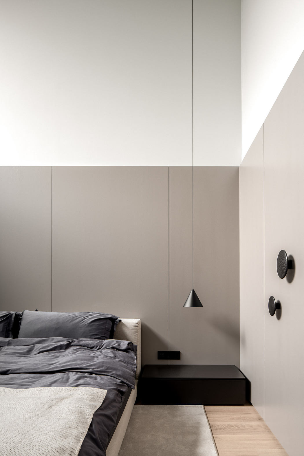 Minimalist bedroom with monochromatic tones and sleek design.