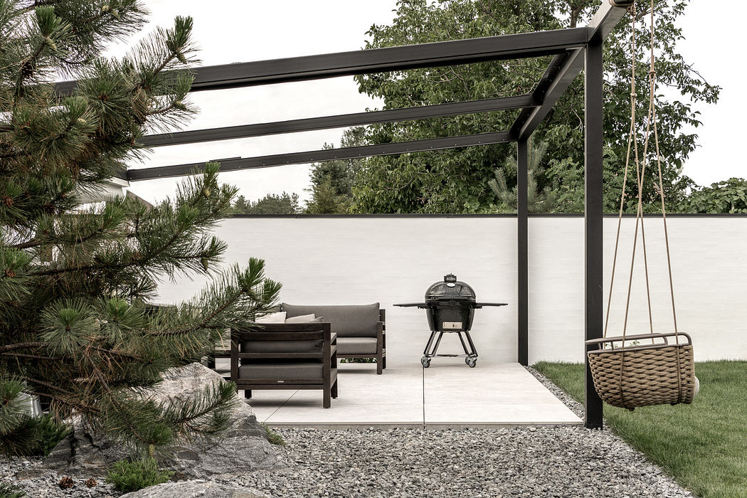 Minimalist outdoor patio with sleek furniture and grill.