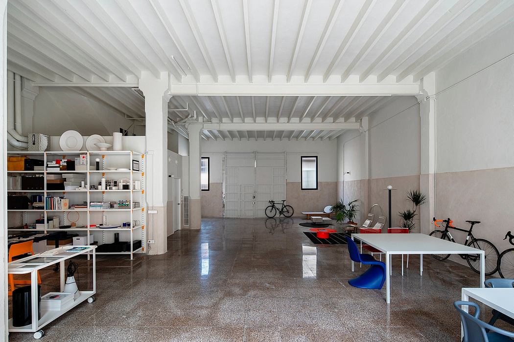 Minimalist modern room with shelves, tables, and bicycles.