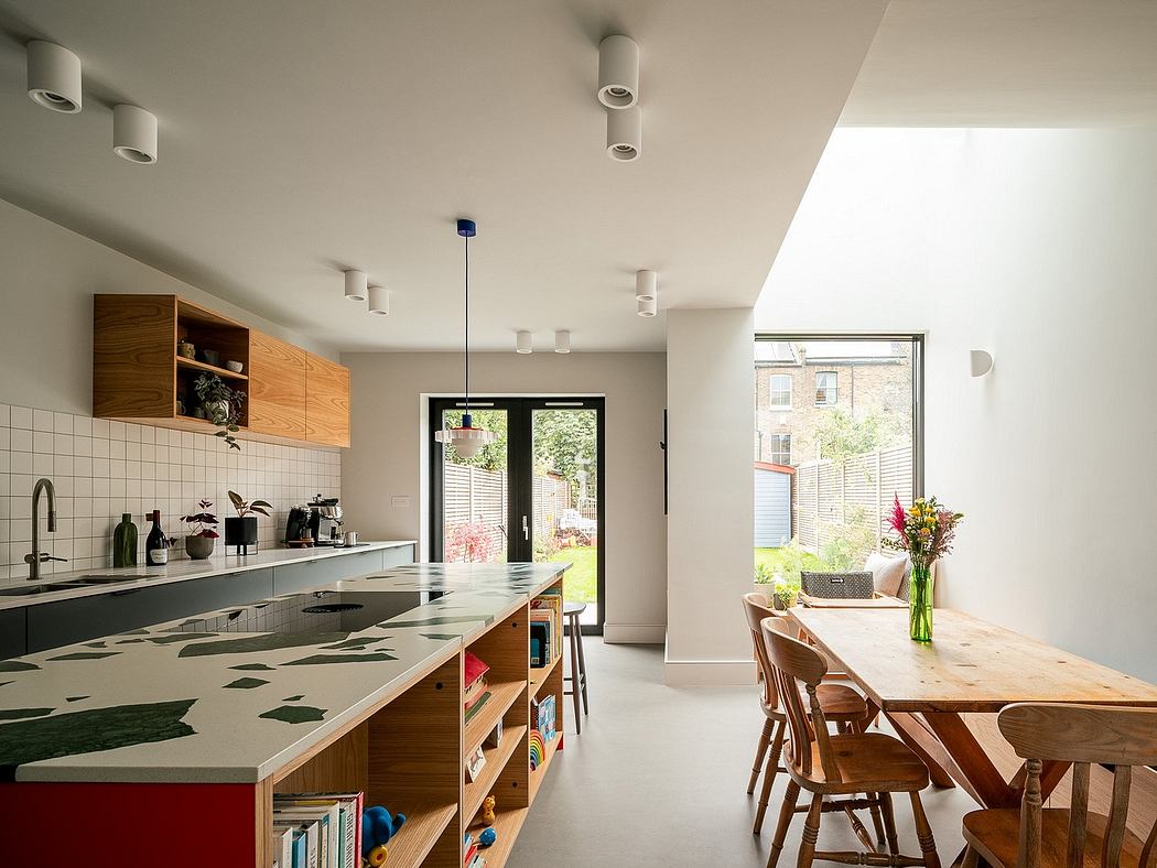 Contemporary kitchen with colorful island and wooden details.