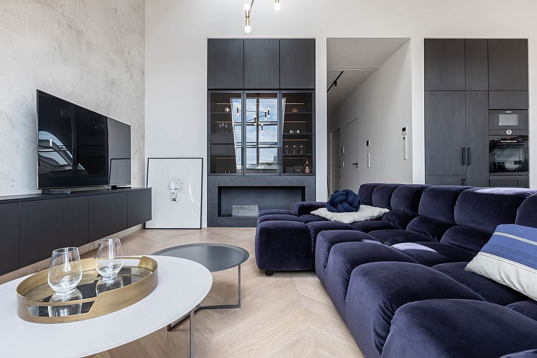 Modern living room with a large blue sectional sofa, black cabinetry, and a