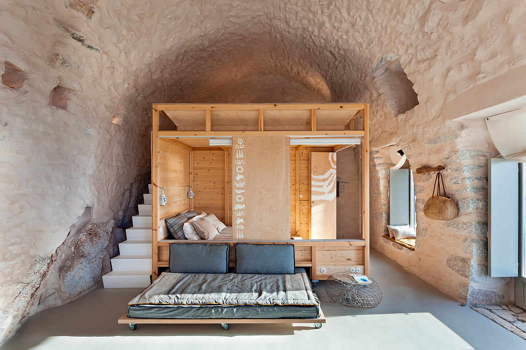 A cozy nook carved into an earthy cave, featuring natural stone walls, wooden furnishings, and a minimalist design aesthetic.