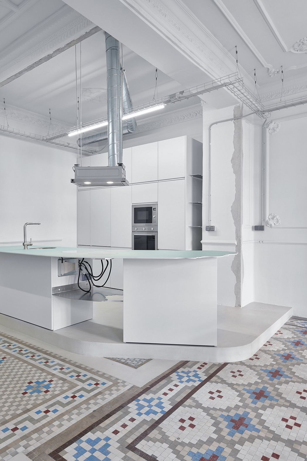 Modern kitchen with sleek white cabinetry, glass-enclosed appliances, and a tiled floor.
