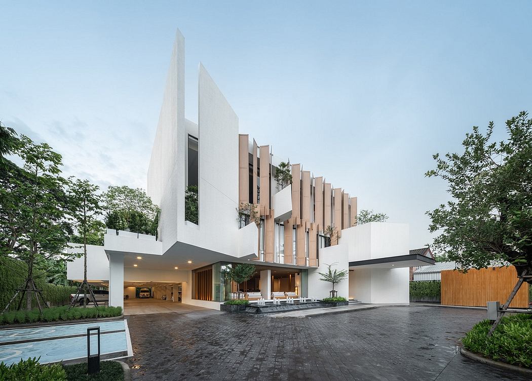 Contemporary house with geometric white façade and vertical wooden slats.
