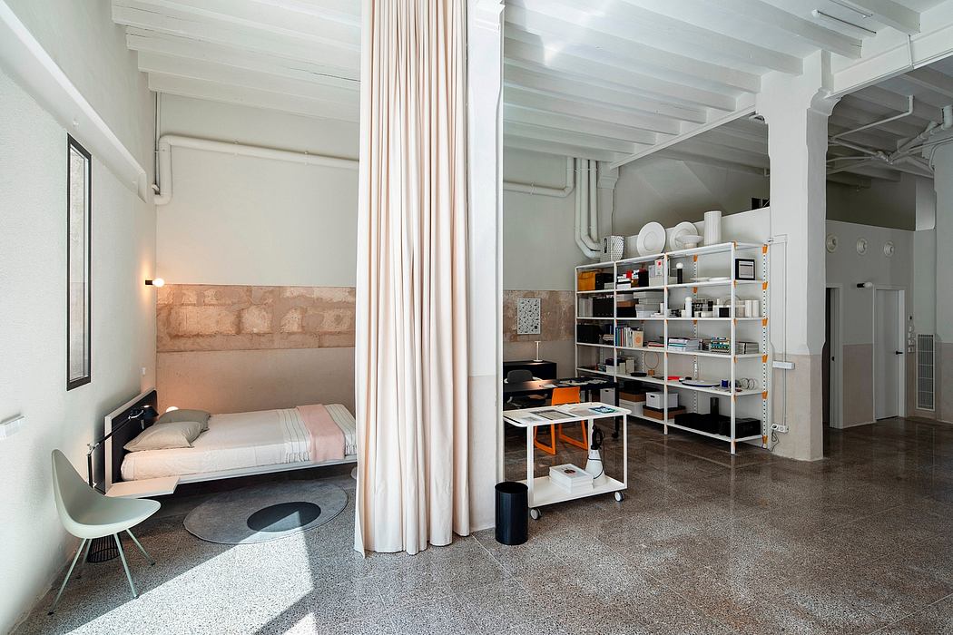 Minimalist interior with white beams, polished floors, and simple furniture.