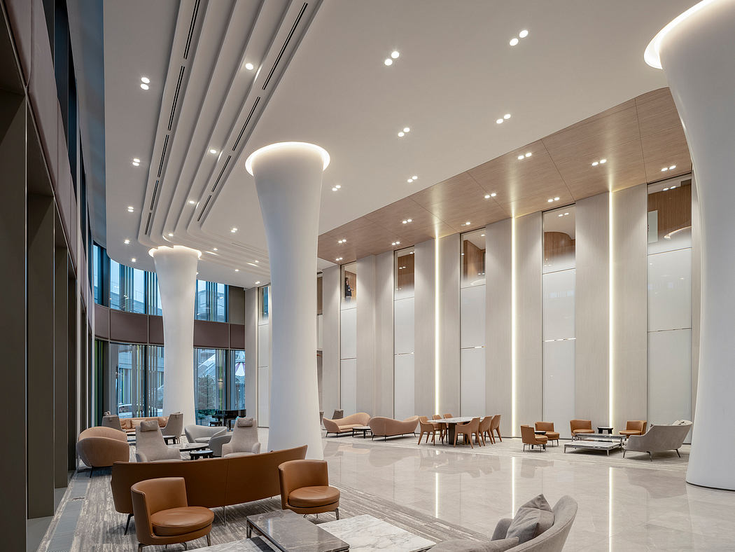 Modern lobby interior with sleek furniture and column lighting.