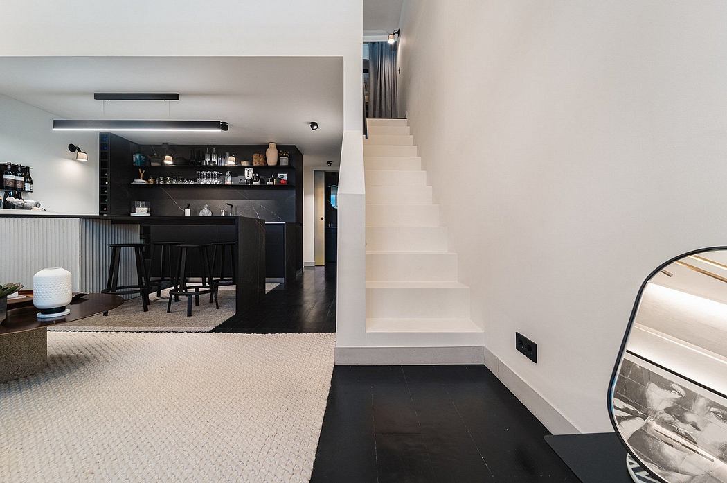 Modern home interior with a bar area and a white staircase.