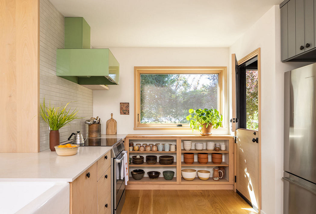 Bright minimalist kitchen with wooden shelves and greenery.