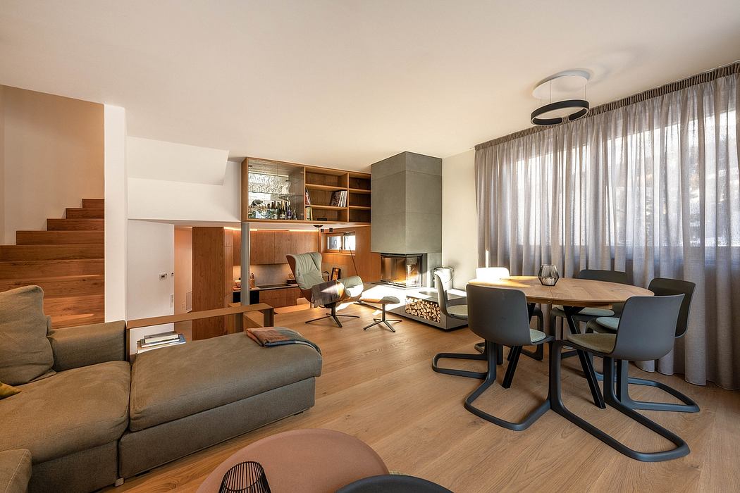 A modern open-concept living space with wood floors, built-in shelving, and dining area.