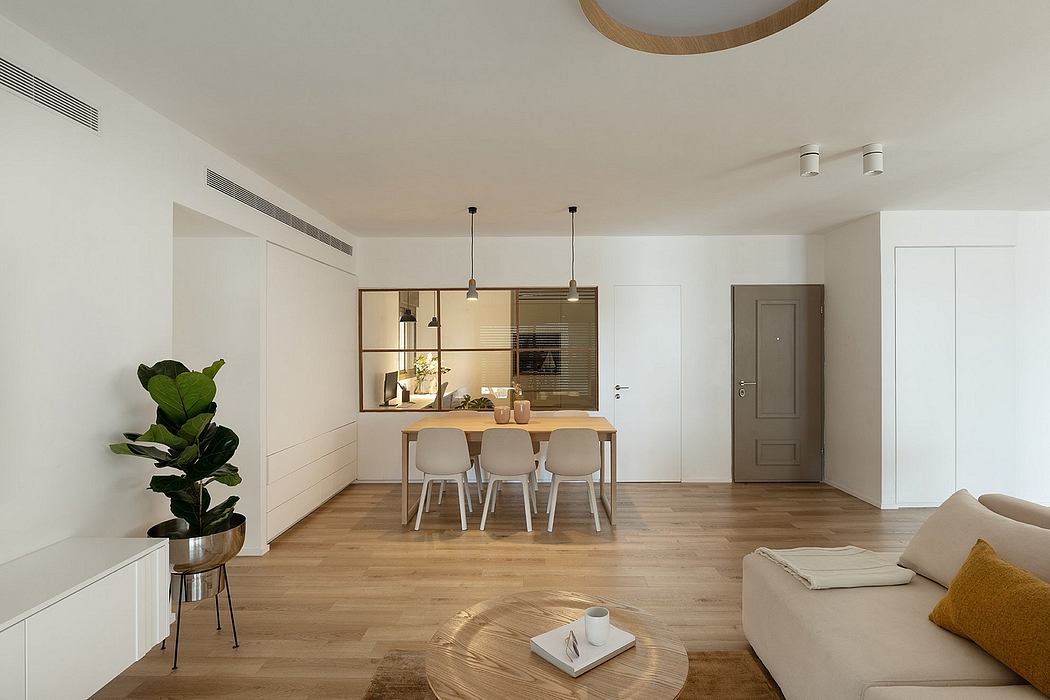 Bright, minimalist interior with an open-plan kitchen and living space, light wood floors