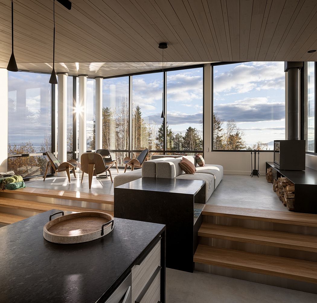 Contemporary living room with panoramic windows and forest view.