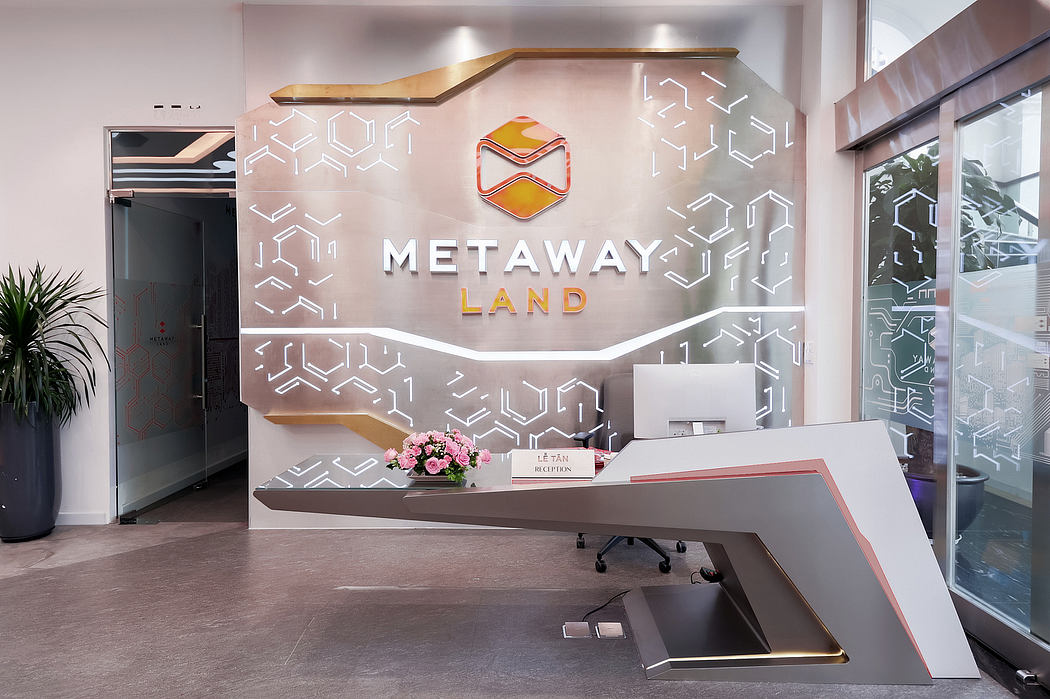 Sleek, modern office lobby with geometric wall patterns, gold accents, and reception desk.