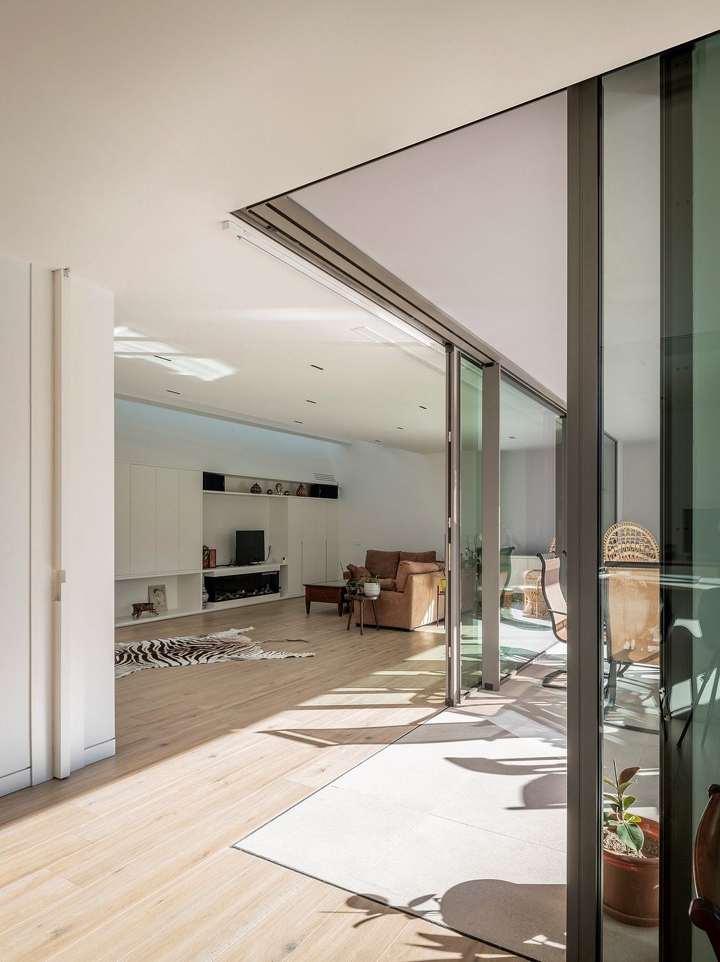 Modern living room with large sliding glass door open to patio.