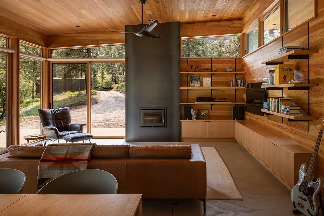 Cozy wooden cabin interior with fireplace and built-in shelves.