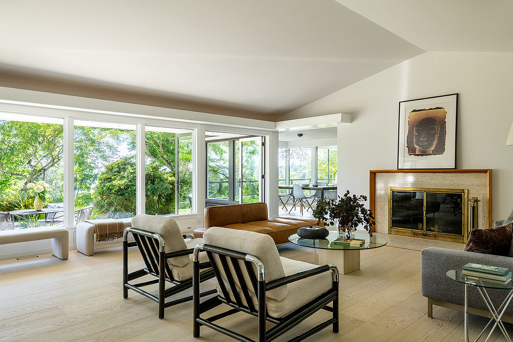 Bright, airy living room with large windows, stylish furniture, and a sleek fireplace.
