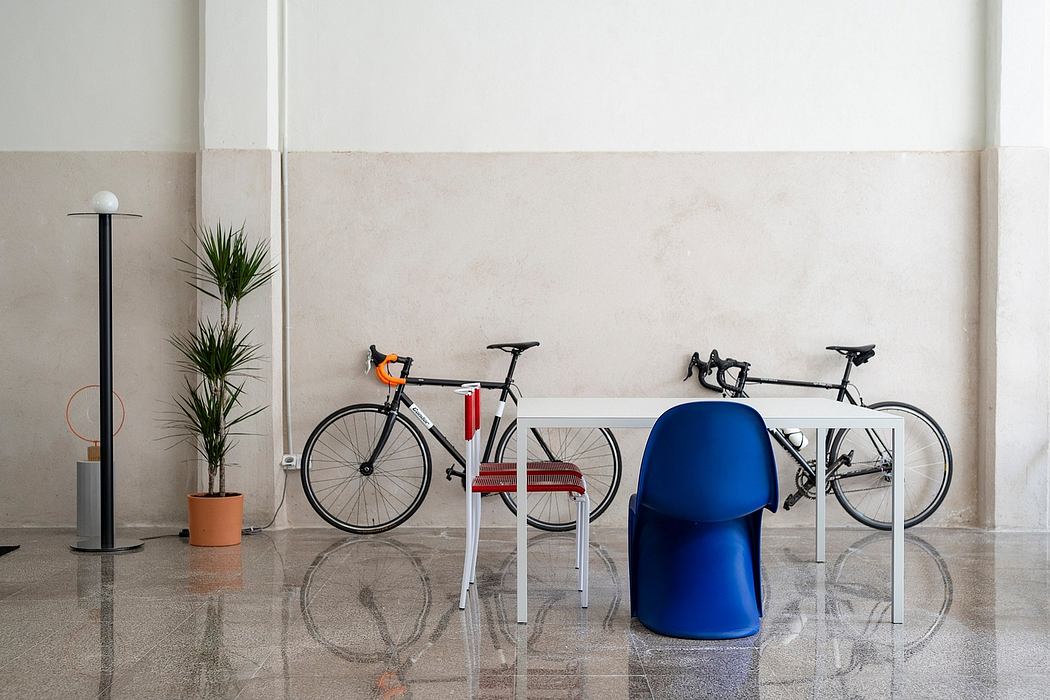 Modern lobby with bicycles, a chair, and a floor lamp.