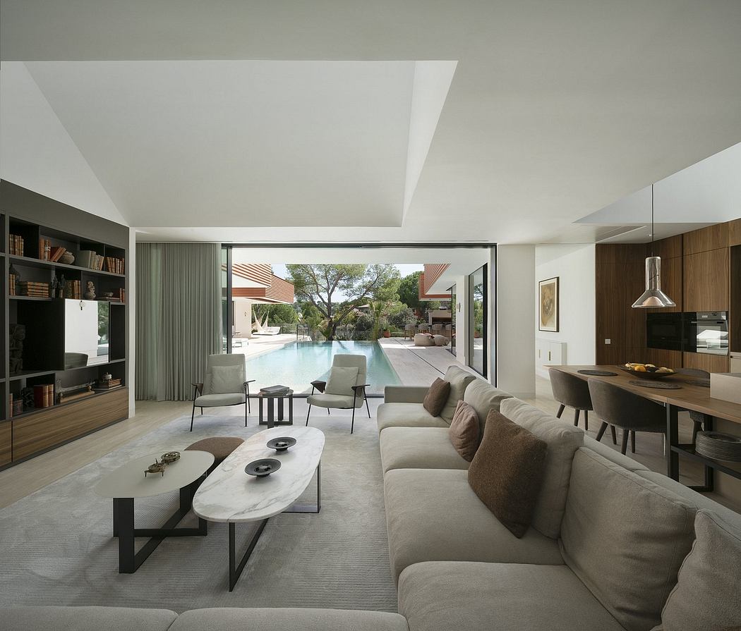 Sleek modern home with open floor plan, large windows, pool, and contemporary furnishings.