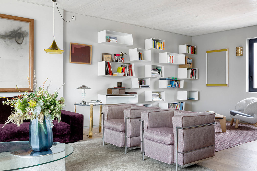 Modern living room with wall-mounted shelves, art, and stylish furniture.