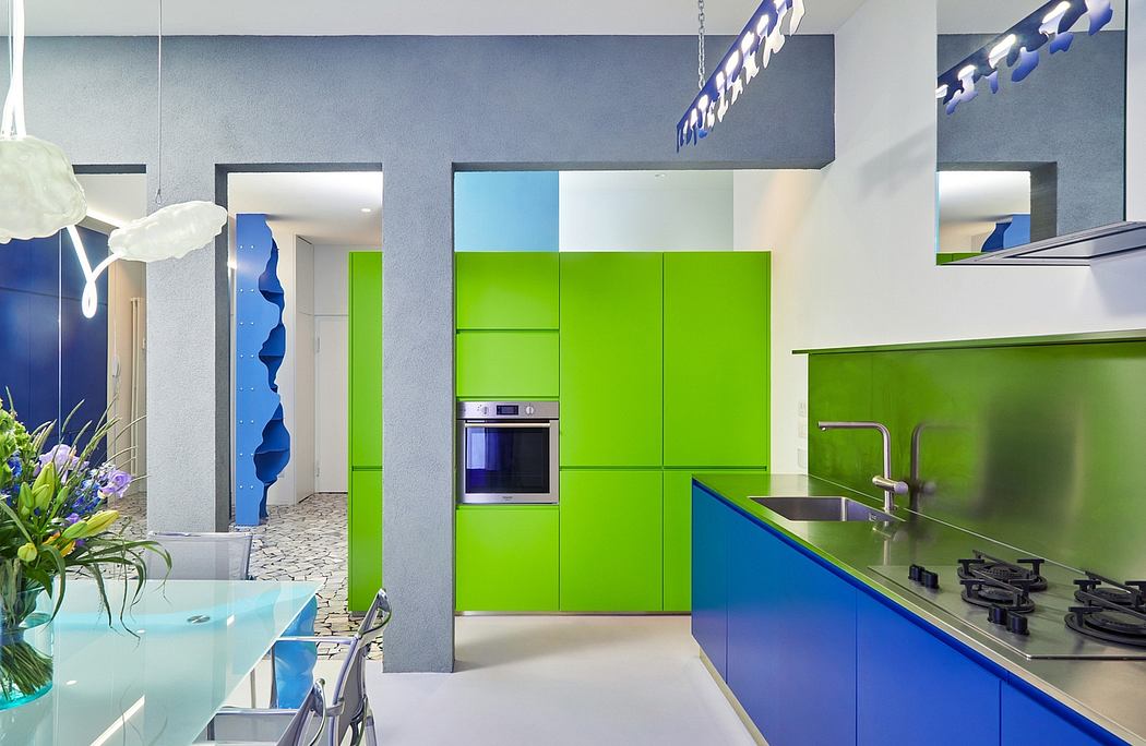 Modern kitchen with colorful, geometric cabinets and lighting fixtures in a minimalist design.