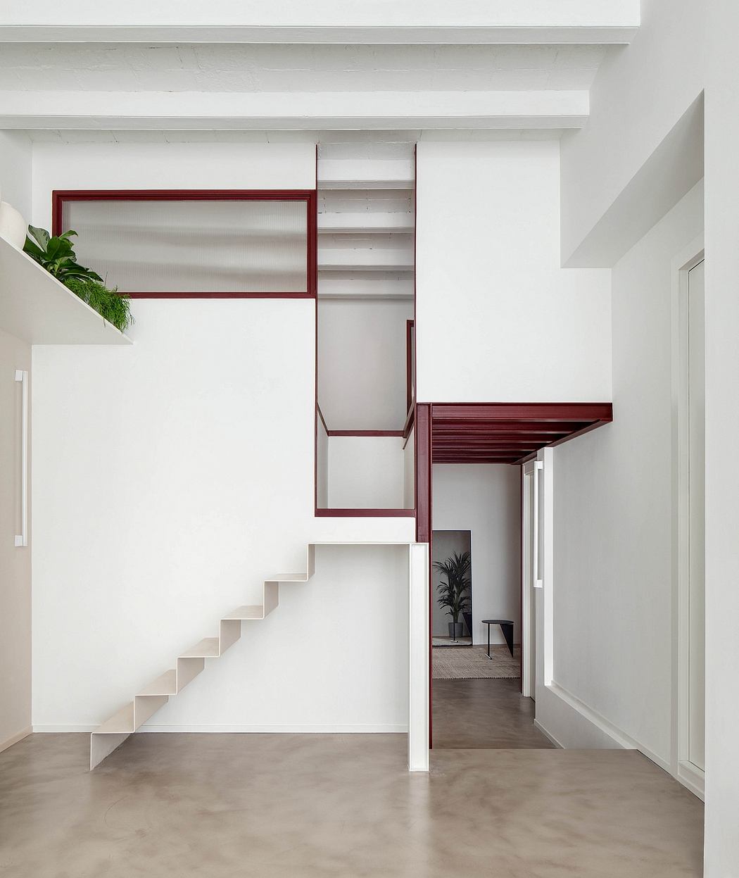 Minimalist white staircase with red accents and clean lines.