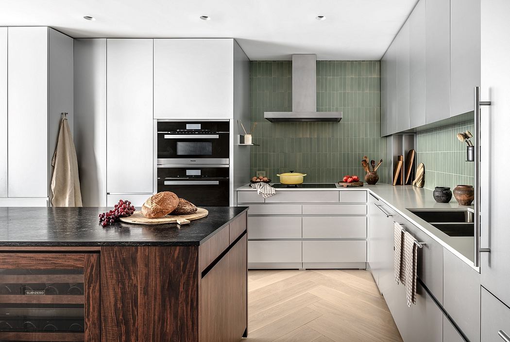 Well-designed kitchen with modern cabinets, tile backsplash, and wood-paneled island.