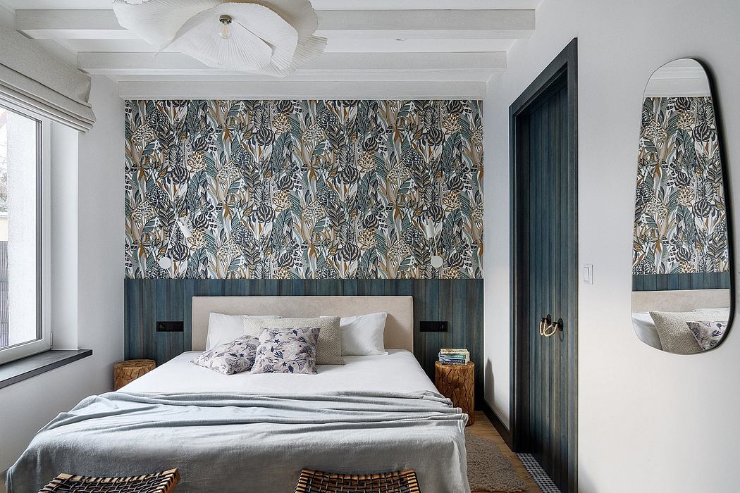 Modern bedroom with patterned wallpaper, white bedding, and a ceiling fan.