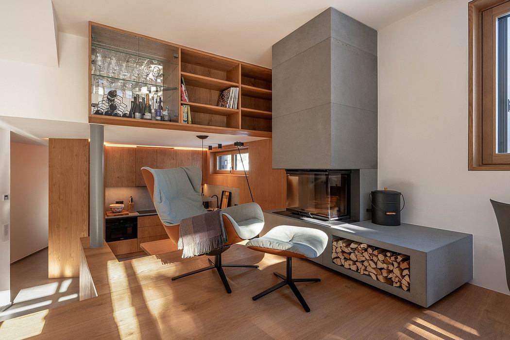 Cozy living space with wood-paneled shelving, concrete fireplace, and modern armchair.