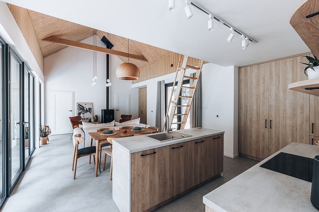 Modern open-plan kitchen and dining area with wooden beams, pendant lights, and integrated appliances.