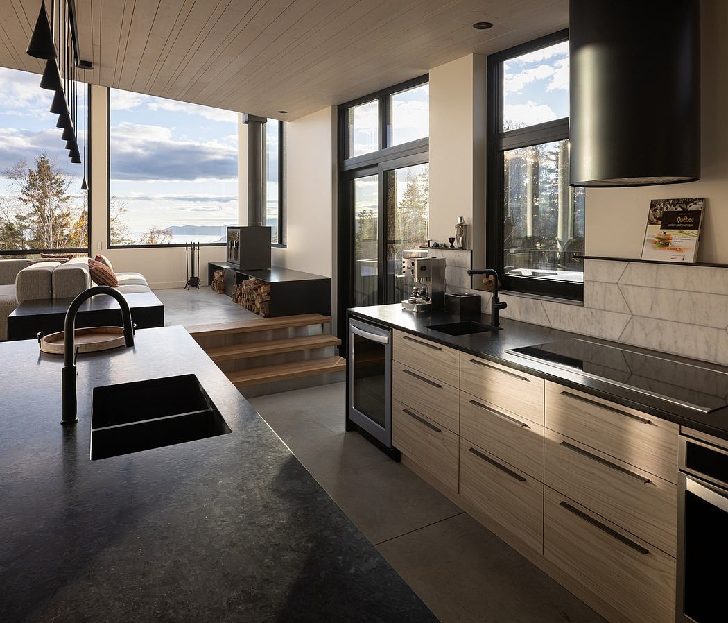 Modern kitchen interior with wood accents and a lake view through large windows.