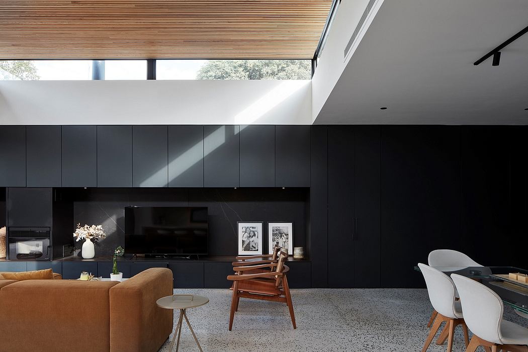 Modern living room with black walls, wooden ceiling, and stylish furniture.