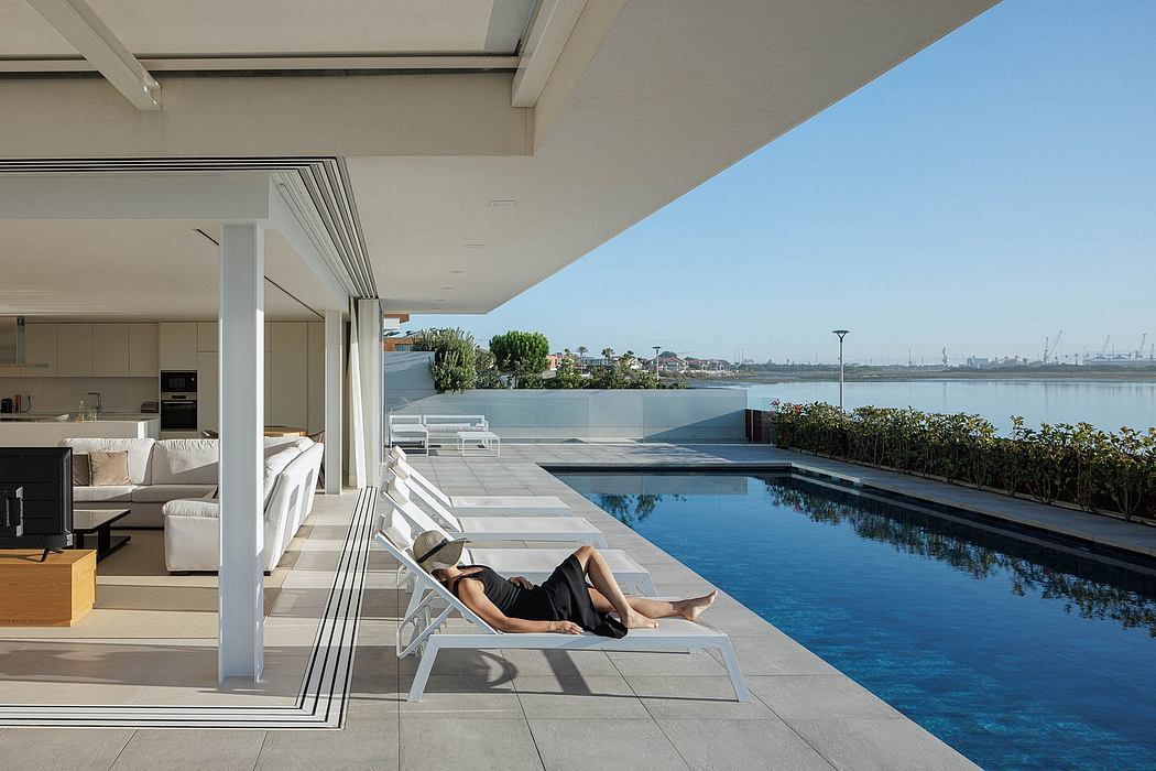 Sleek, modern residence with a stunning pool overlooking a scenic cityscape.