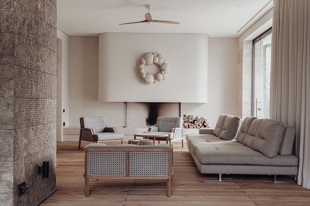 Spacious, modern living room with brick accent wall, plush sofa, and decorative wreath.