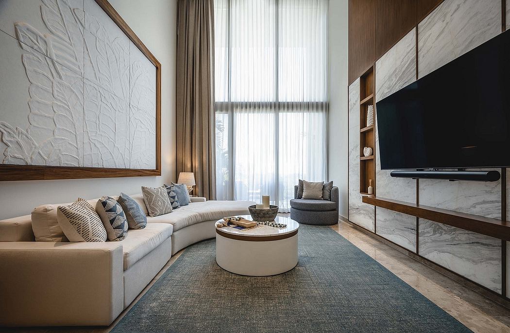 Elegant living room with a beige sectional sofa, round coffee table, and wall