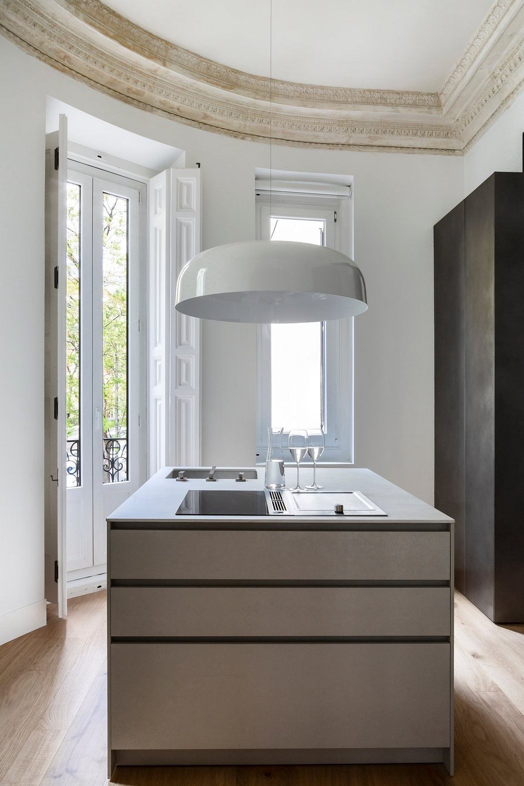 Elegant kitchen with a grand arched ceiling and minimalist cabinetry design.