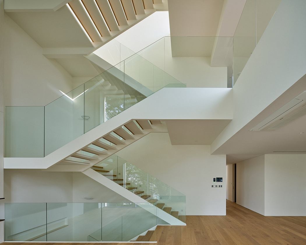 Minimalist interior with sleek white staircases and glass balustrades.