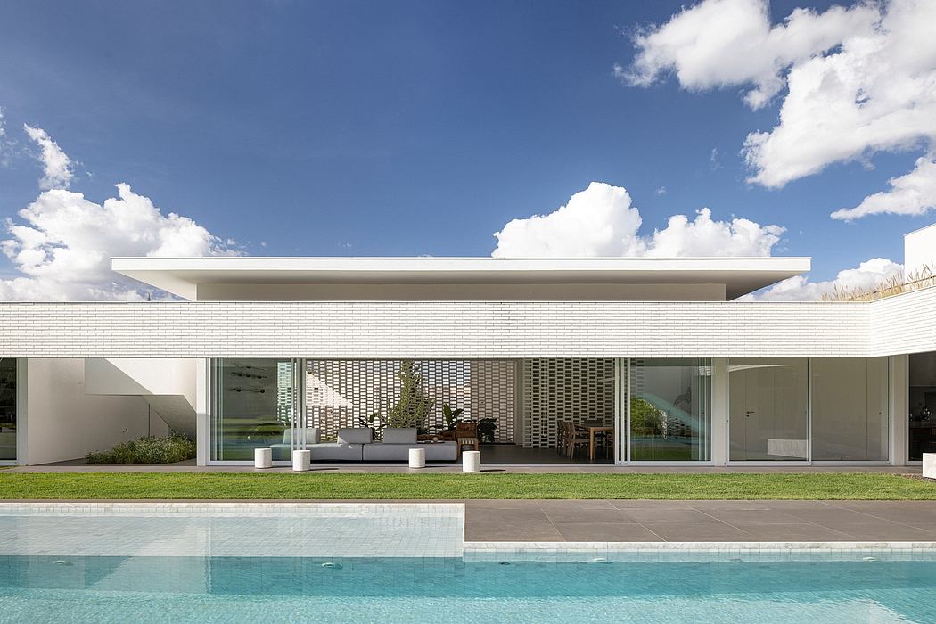 Contemporary architectural design featuring clean lines, expansive windows, and a pool.