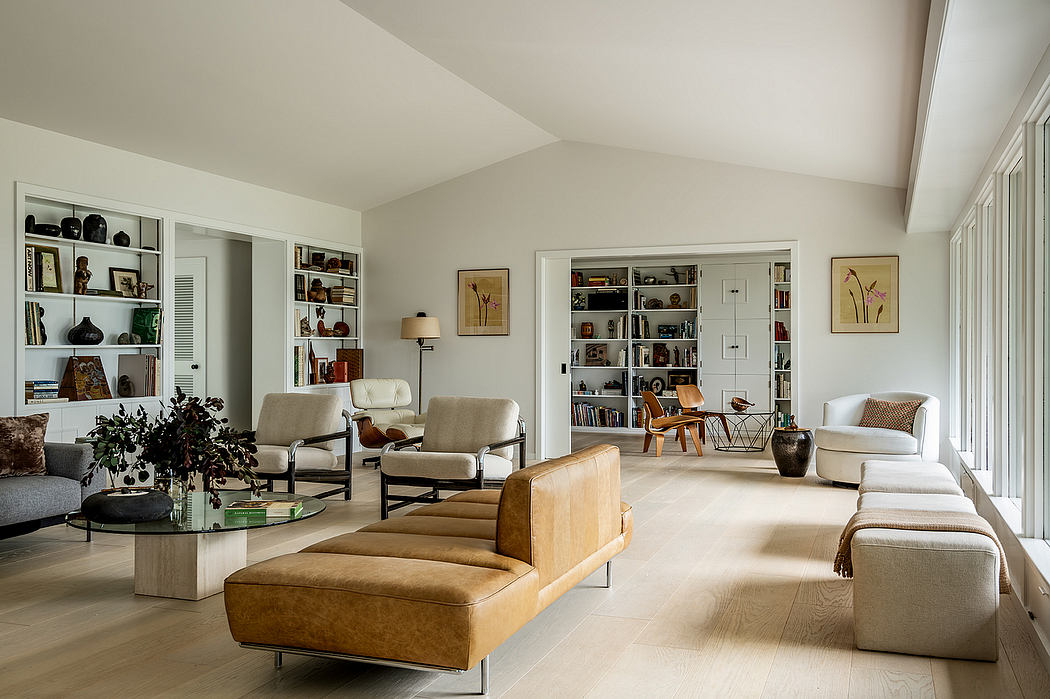 Spacious living room with modern furniture, built-in bookshelves, and natural light.