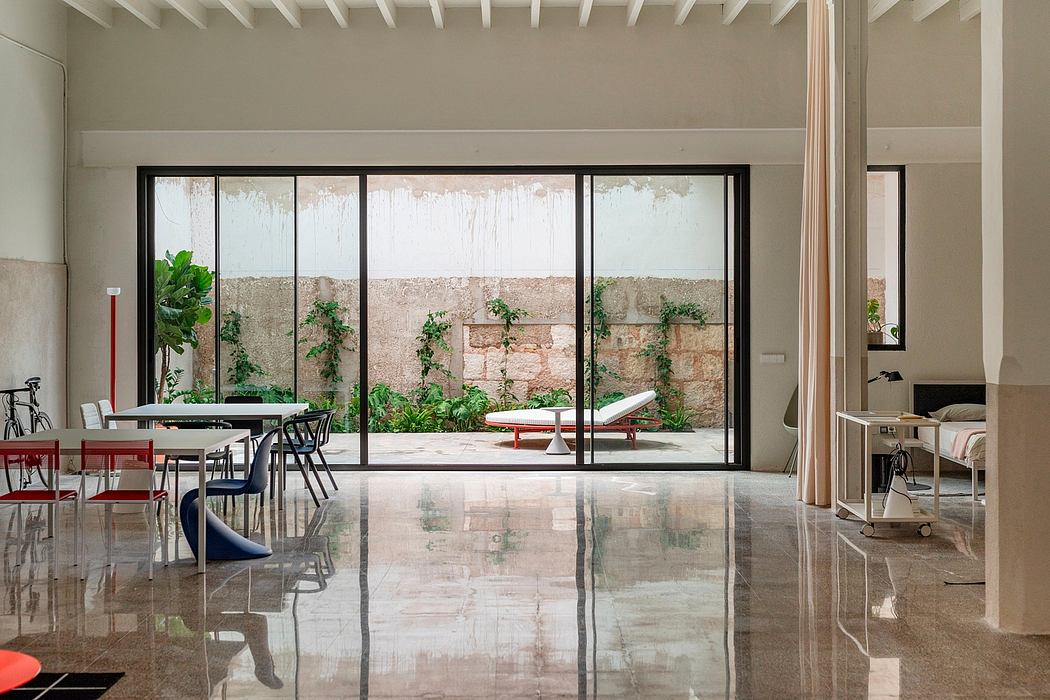 Contemporary interior with sleek surfaces, large windows, and minimalist decor.