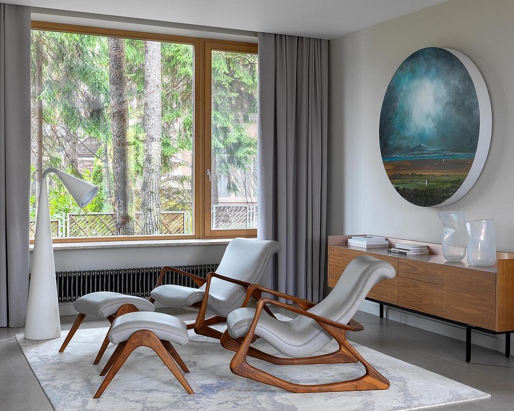 Cozy living room with wooden reclining chairs, artwork, and large window overlooking lush greenery.