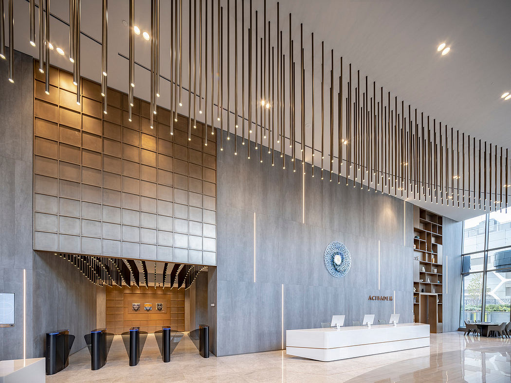 Modern lobby with vertical metal rods, reception desk, and gray tones.