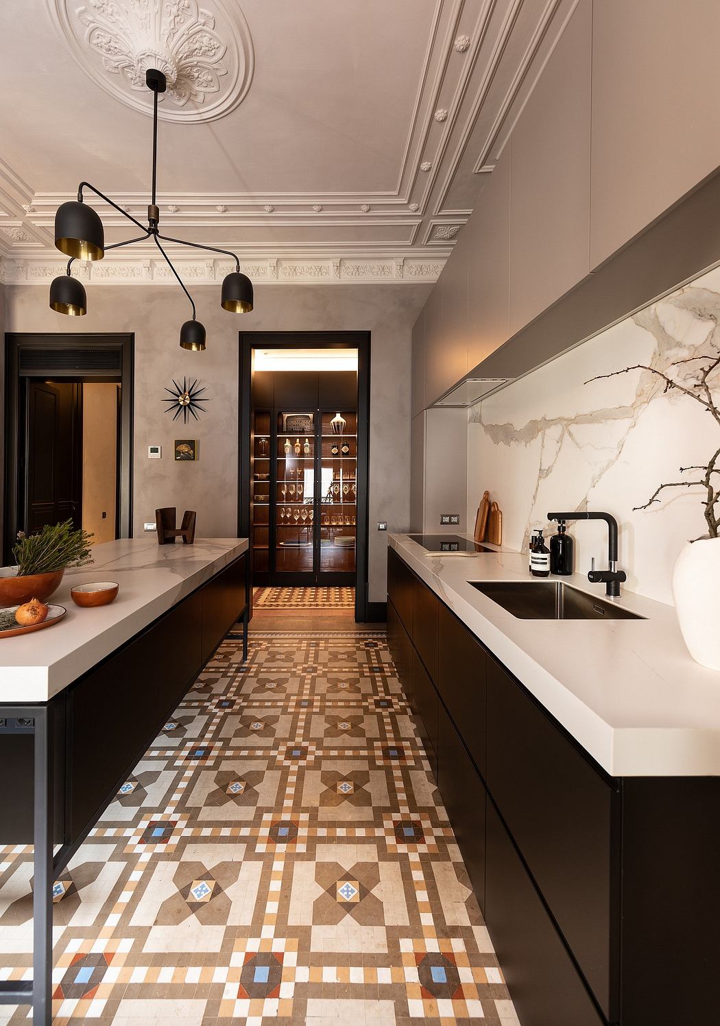 Elegant kitchen with patterned floor tiles, marble backsplash, and hanging lights